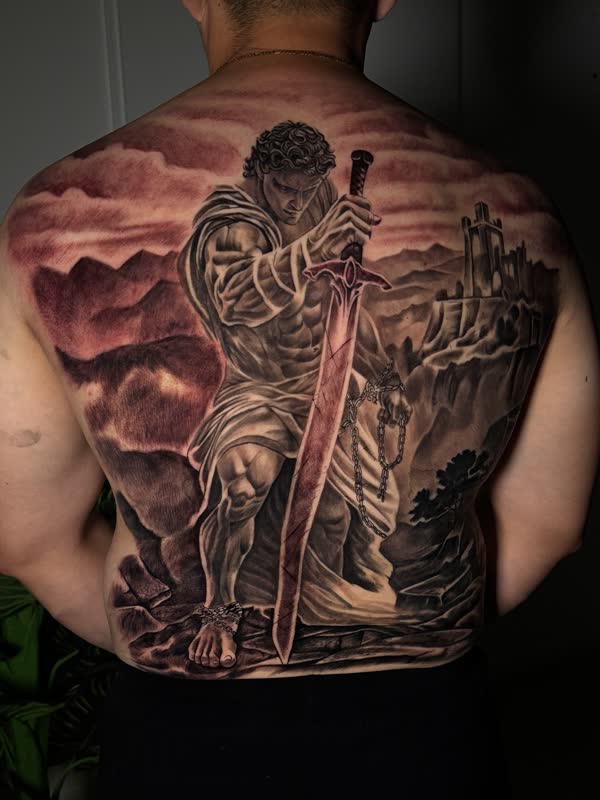 Full back piece of a lone swordsman beneath a red sky